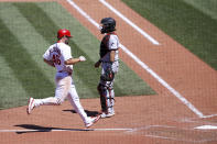 St. Louis Cardinals' Paul Goldschmidt, left, scores a run as Miami Marlins catcher Jorge Alfaro, right, looks on during the ninth inning of a baseball game Wednesday, June 16, 2021, in St. Louis. (AP Photo/Scott Kane)