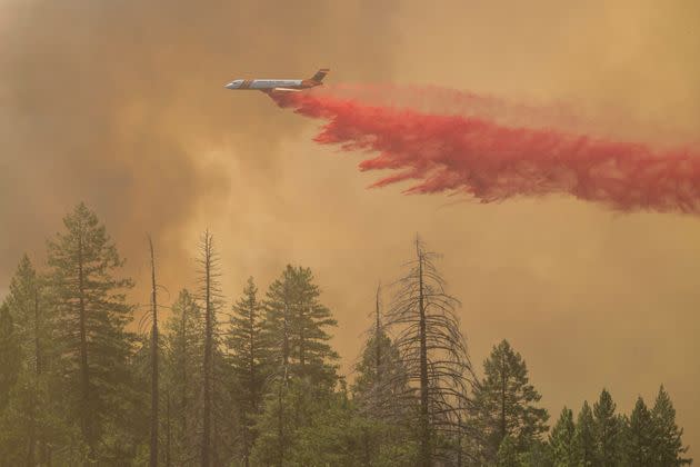 A plane drops fire retardant on the Park Fire near Forest Ranch, Calif., on Sunday.