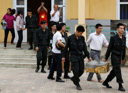 Hostages, who were originally held by villagers in a land dispute, walk out after the villagers released them in Dong Tam, outside Hanoi, Vietnam April 22, 2017. REUERS/Kham