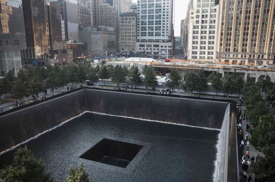 People gather around the South Tower pool during memorial ceremonies marking the 12th anniversary of the 9/11 attacks on the World Trade Center in New York September 11, 2013. (REUTERS/Andrew Burton)