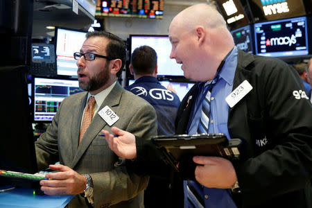Traders work on the floor of the New York Stock Exchange (NYSE) in New York City, U.S., November 23, 2016. REUTERS/Brendan McDermid
