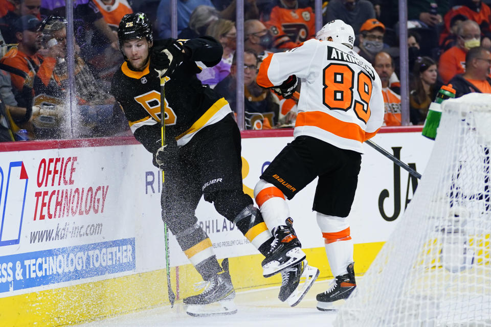 Philadelphia Flyers' Cam Atkinson, right, and Boston Bruins' Brandon Carlo collide during the second period of an NHL hockey game, Wednesday, Oct. 20, 2021, in Philadelphia. (AP Photo/Matt Slocum)