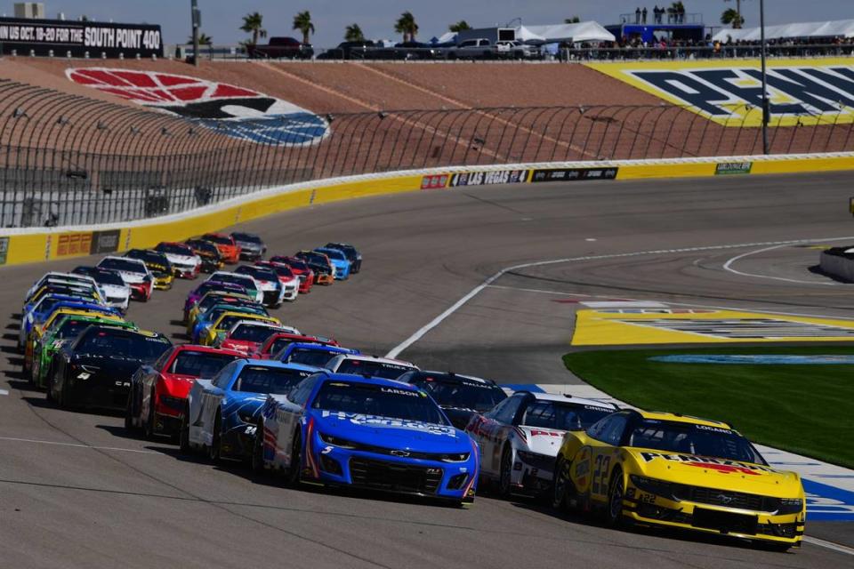 Joey Logano (22) and Kyle Larson (5) lead the NASCAR Cup Series field on Sunday at the start of the Pennzoil 400 at Las Vegas Motor Speedway. Gary A. Vasquez/USA TODAY Sports