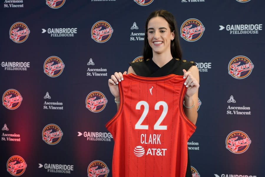 Indiana Fever’s Caitlin Clark holds her jersey following a WNBA basketball news conference, Wednesday, April 17, 2024, in Indianapolis. (AP Photo/Darron Cummings)