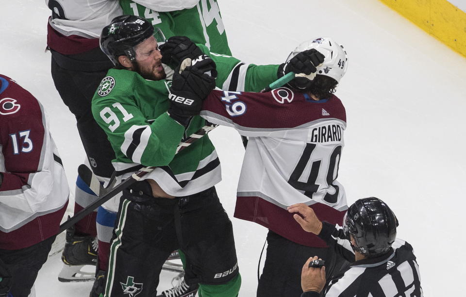 Dallas Stars' Tyler Seguin (91) and Colorado Avalanche's Samuel Girard (49) tangle during second-period NHL Western Conference Stanley Cup playoff action in Edmonton, Alberta, Sunday, Aug. 30, 2020. (Jason Franson/The Canadian Press via AP)