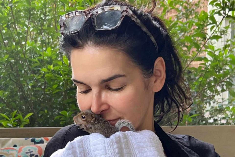 <p>Carrie Frank</p> Angie Harmon and her rescue squirrel, Thomas