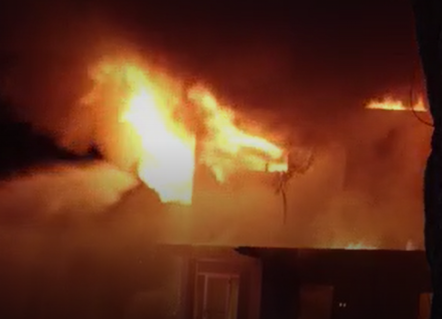 An image from the Saturday fire at the former Rock Island Livestock Auction Barn, 534 34th Ave.