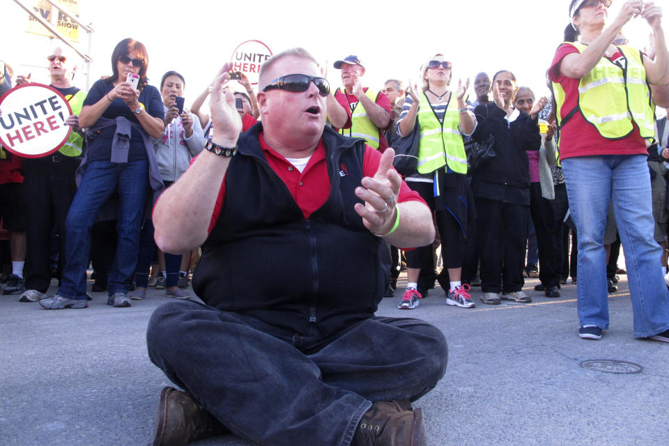 FILE - In This Oct. 8, 2014 photo, Bob McDevitt, president of local 54 of the Unite-HERE casino workers' union, sits on the roadway of the Atlantic City Expressway during a traffic-blocking protest in Atlantic City N.J. against the elimination of employee benefits at the Trump Taj Mahal casino. McDevitt is stepping down as president of the main Atlantic City casino workers union, Local 54 of Unite Here, after 26 years as one of the most powerful people in Atlantic City. On May 1, 2023, he'll become head of the union's national pension plan. (AP Photo/Wayne Parry, File)