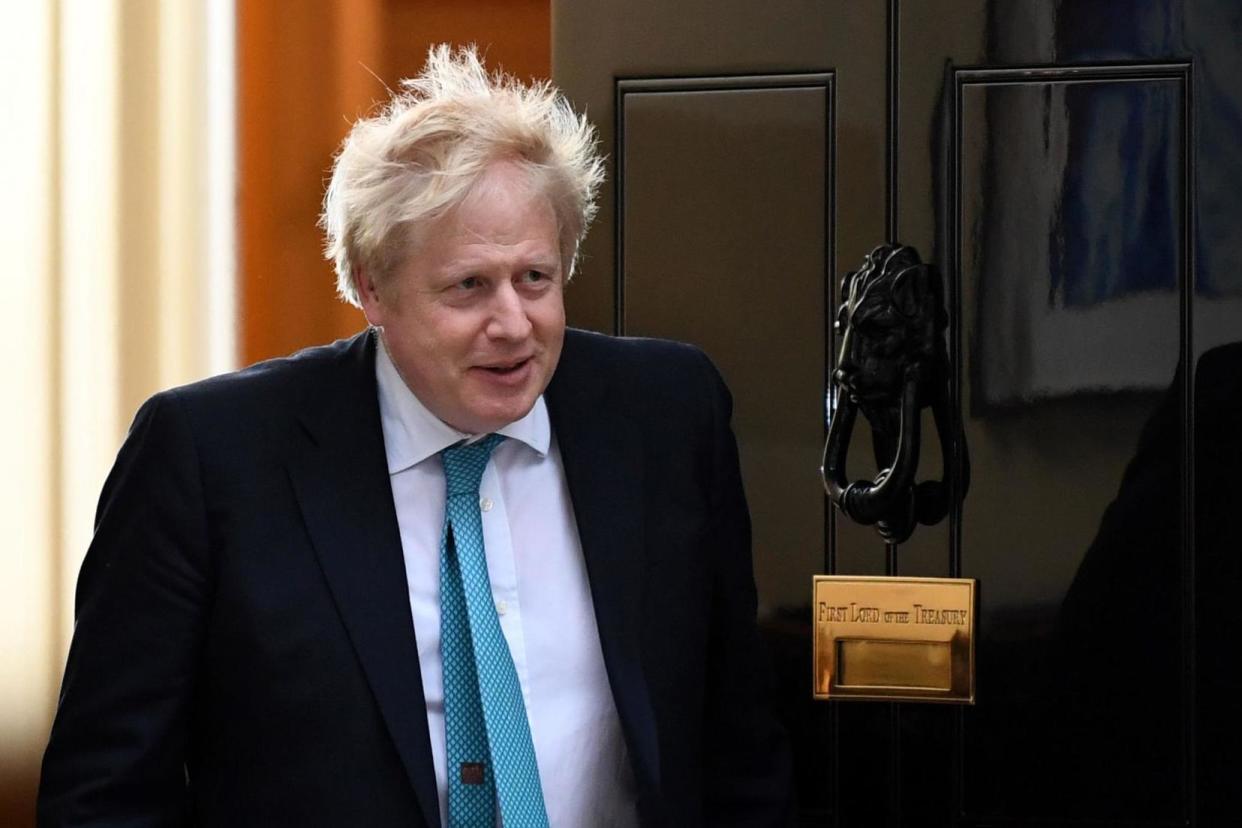 Boris Johnson exits 10 Downing Street on Tuesday: AFP via Getty Images