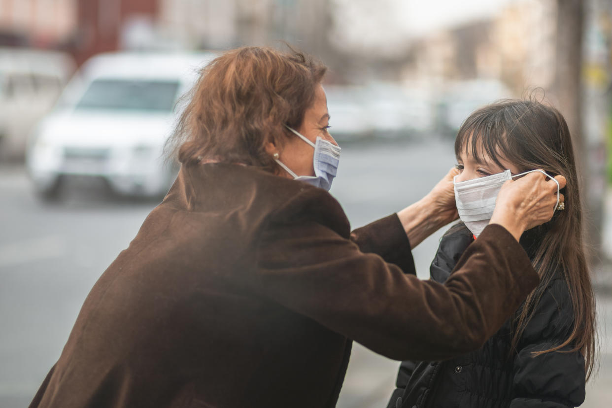 woman are going to work.she wears N95 mask.prevent PM2.5 dust and smog, mother and child wearing a mask to protect their child from air pollution and infectious diseases