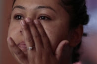 In this Feb. 13, 2020 photo, Alondra Mora wipes away a tear as she talks about her late husband, Miguel Flores Lopez, during an interview in the two-bedroom home where they lived with their four children, in Irapuato, Guanajuato state, Mexico. Flores Lopez, 38, disappeared on Jan. 10 after he was dragged from his taxi by armed men. Mora and her husband came to Guanajuato from their native gang-plagued state of Michoacán in mid-2019, looking to build her shoe-retail business in what they viewed as a more prosperous state. (AP Photo/Rebecca Blackwell)