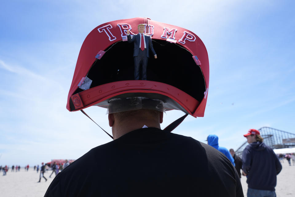 Anthony Pahopin wears an over-sized Donald Trump cap before a campaign rally for Republican presidential candidate former President Trump in Wildwood, N.J., Saturday, May 11, 2024. (AP Photo/Matt Rourke)