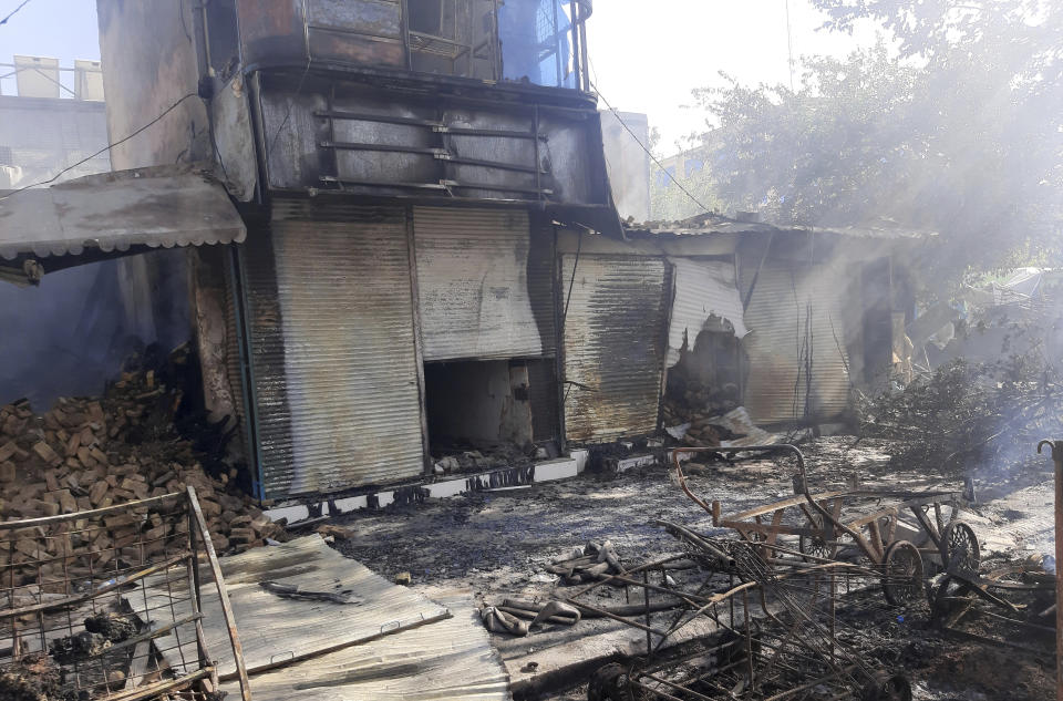 Smoke rises from damaged shops after fighting between Taliban and Afghan security forces in Kunduz city, northern Afghanistan, Sunday, Aug. 8, 2021. Taliban fighters Sunday took control of much of the capital of Kunduz province, including the governor's office and police headquarters, a provincial council member said. (AP Photo/Abdullah Sahil)