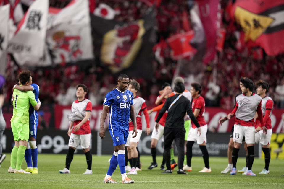 Odion Ighalo of Saudi Arabia's Al Hilal, center, reacts as players of Japan's Urawa Red Diamonds, in red jersey, celebrate after the AFC Champions League final match at Saitama Stadium in Saitama, near Tokyo, Saturday, May 6, 2023. (AP Photo/Toru Hanai)