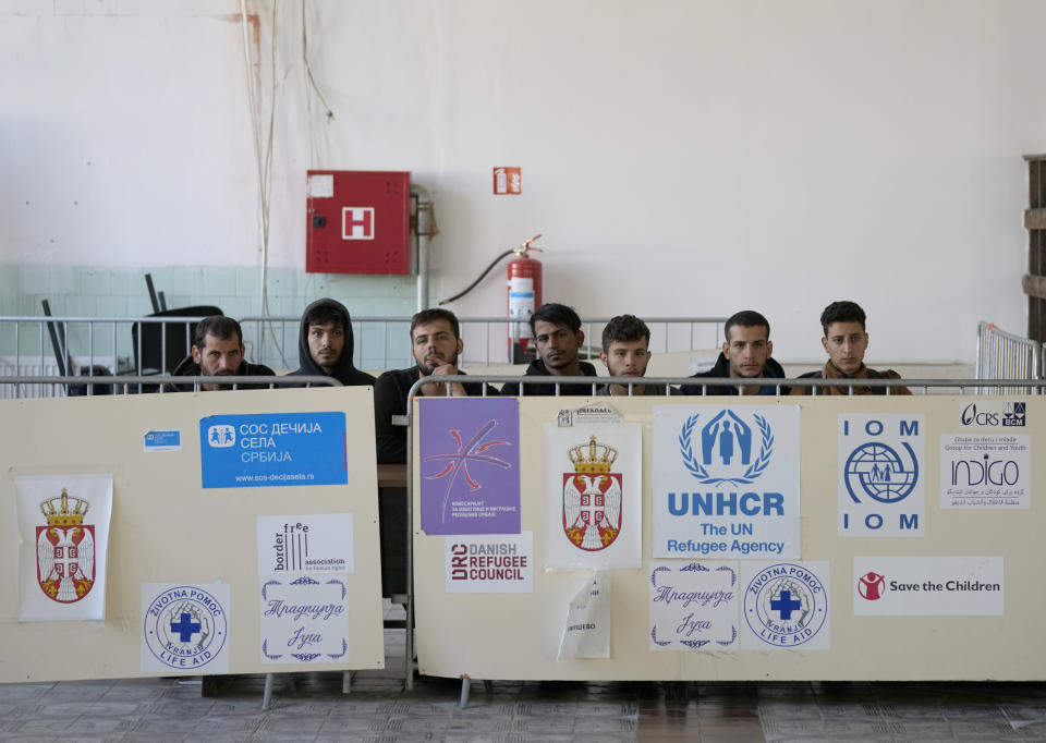 A group of migrants waiting to be registered at reception camp near the southern border with North Macedonia, in Presevo, Serbia, Wednesday, Oct. 19, 2022. Located at the heart of the so-called Balkan route, Serbia recently has seen a sharp rise in arrivals of migrants passing through the country in search of a better future in the West. (AP Photo/Darko Vojinovic)