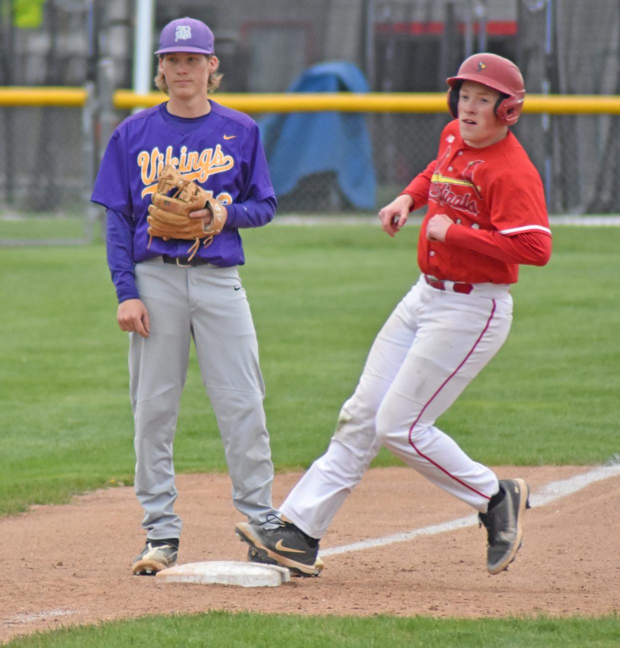 Coldwater's Logan Smiertka rounds third on a passed ball while Bronson third baseman James Jourdan looks on