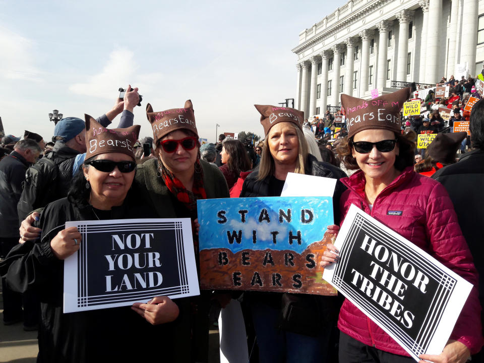 Protesters hold signs during a rally against Trump administration plans to cut the sizes of two national monument areas in the state that are protected from mining and drilling, at the state capitol in Salt Lake City, Utah, U.S. December 2, 2017. Picture taken December 2, 2017. REUTERS/Emily Means