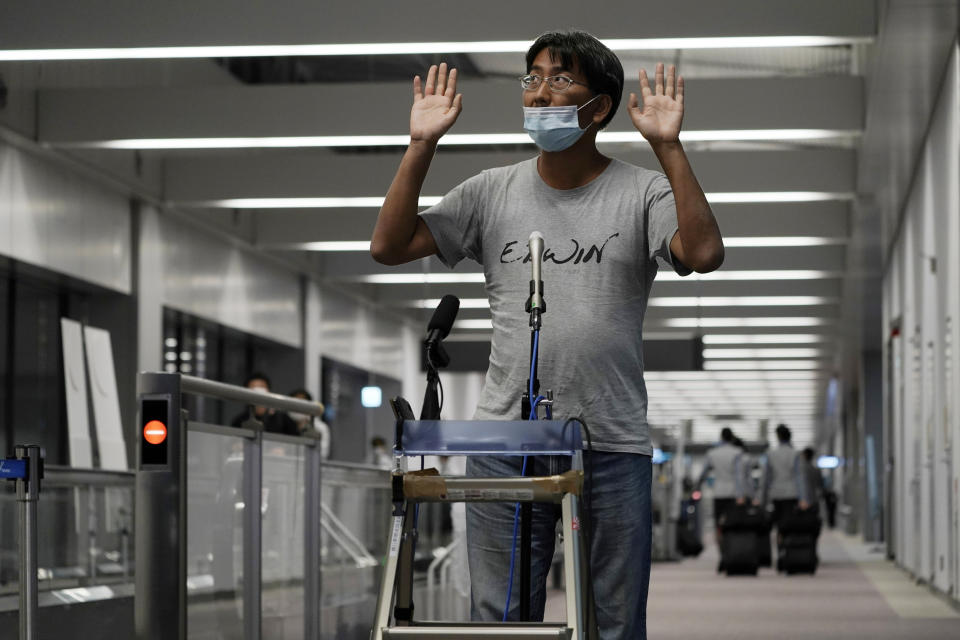 Yuki Kitazumi, a Japanese freelance journalist detained by security forces in Myanmar in mid-April and accused of spreading fake news criticizing the military coup, gestures to speak to the media as he arrives at Narita International Airport, in Narita, east of Tokyo. (AP Photo/Eugene Hoshiko)