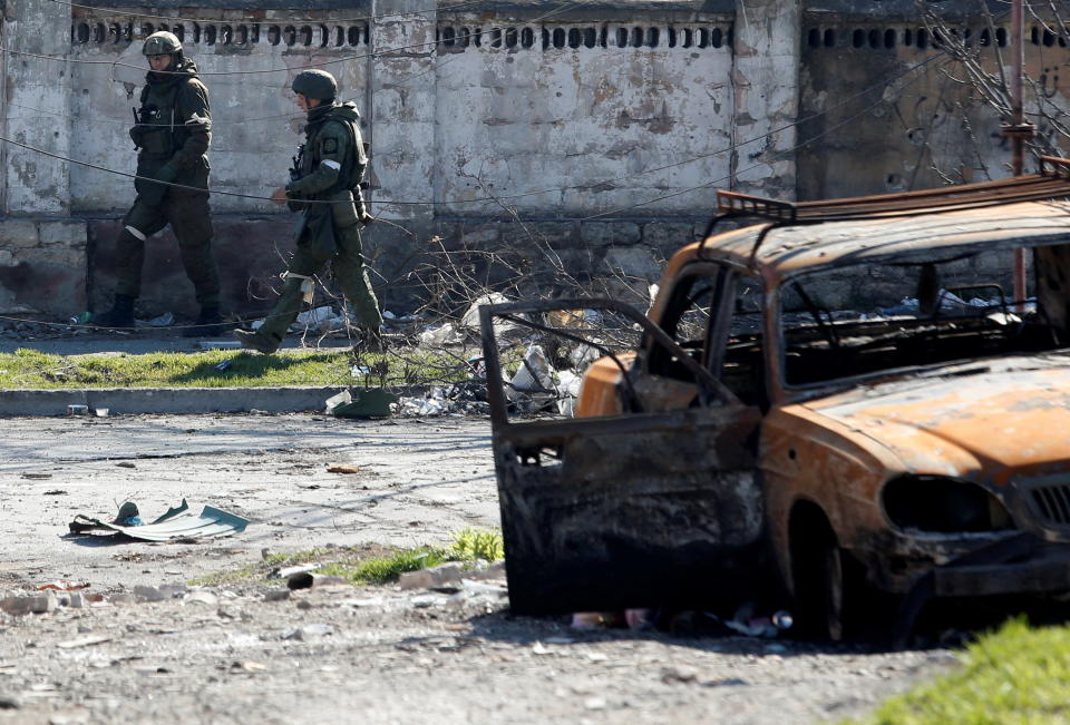 Service members of pro-Russian troops inspect streets during Ukraine-Russia conflict in the southern port city of Mariupol, Ukraine April 7, 2022. REUTERS/Alexander Ermochenko