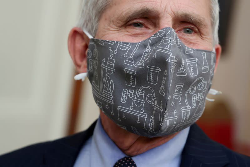 FILE PHOTO: Fauci wears a lab equipment-themed mask as he arrives for a COVID-19 response event with U.S. President Biden at the White House in Washington