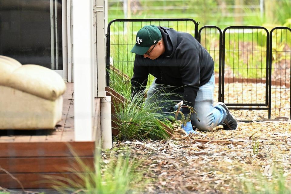 A detective searches the property of Erin Patterson in Leongatha, Australia (AAP Image)