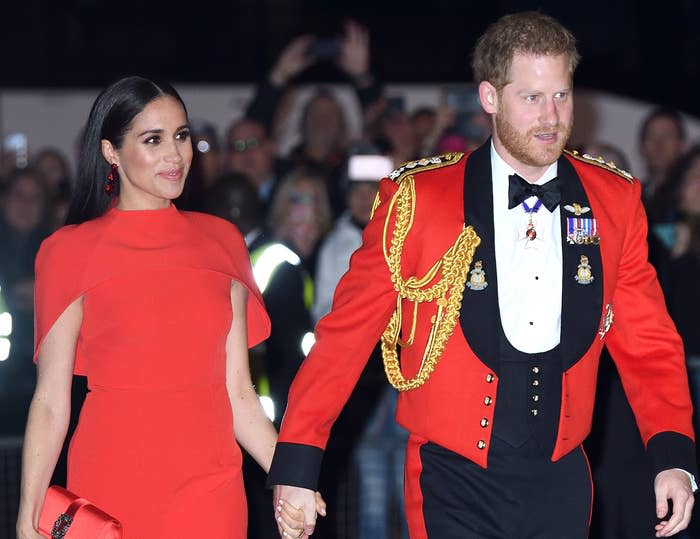 Meghan and Harry hold hands during a royal event