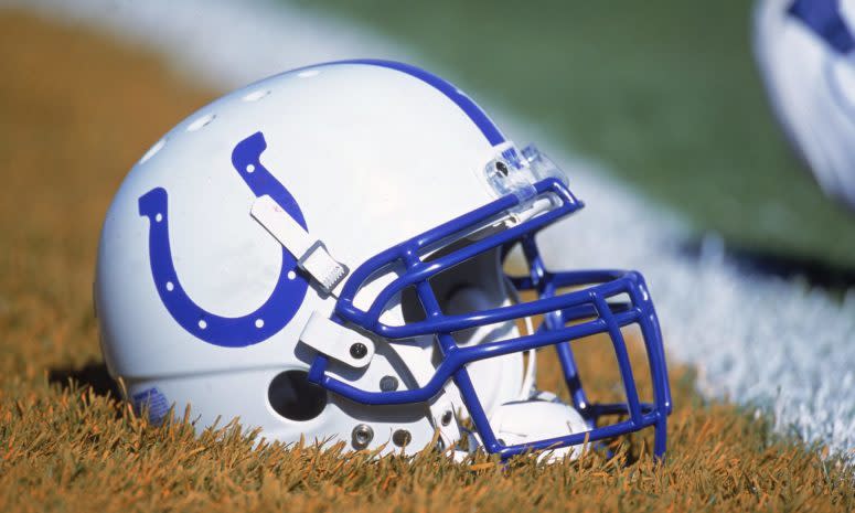 An Indianapolis Colts helmet sitting on the field.