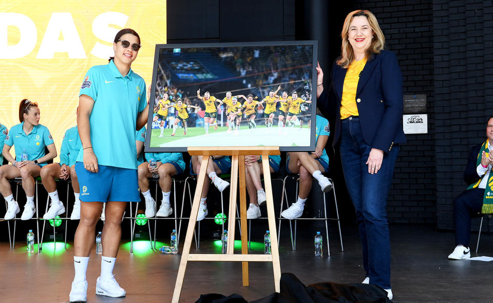 Sam Kerr and Annastacia Palaszczuk, pictured here with a photo memento presented to the Matildas. 