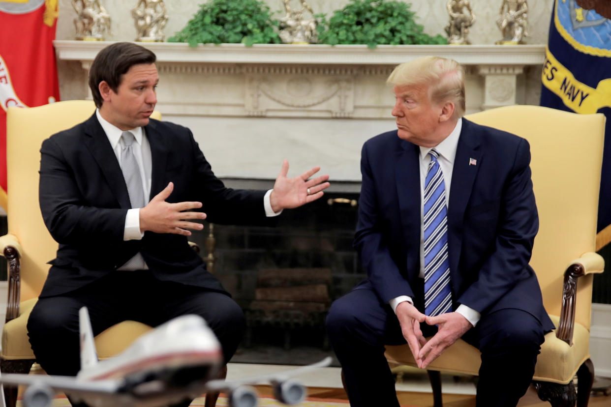 Gov. Ron DeSantis eagerly explains his point, as President Donald Trump looks on without much interest.