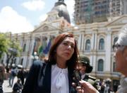 Bolivia's Foreign Minister Karen Longaric speaks to journalists outside of the presidential palace in La Paz