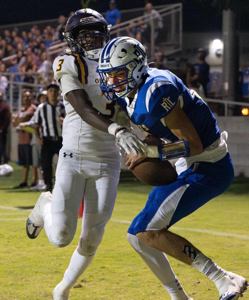 Ripon Christian’s Jace Beidleman holds on to the ball in the end zone for a touchdown as Orestimba’s Daryl Summerfield defends on the pass during the Southern League game in Ripon, Calif., Friday, Sept. 22, 2023.