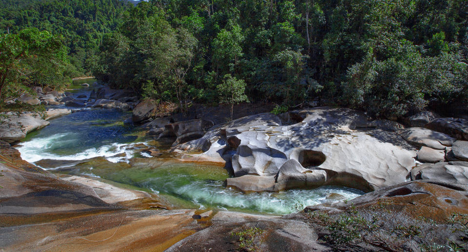 Devil's Pool or Babinda Boulders is a natural pool at the confluence of three streams among a group of boulders near Babinda, Queensland, Australia. The pools have taken 17 lives since 1959. Despite that, this place is an iconic Cairns attraction and popular swimming hole and tourist attraction south of Cairns. It is a classic example of the fast flowing tropical creeks in the area that are perfect for afternoon dips in the cool water to combat the tropical heat. The creek is lined with huge boulders and the clear fresh water weaves between the obstacles to fill large pools where people can swim. Just behind The Boulders is Mt Bartle Frere, Queensland's tallest mountain, from which Babinda Creek's cool water originates. The section of the creek where the water rushes over massive granite boulders, smoothing and shaping them, is referred to as The Babinda Boulders.