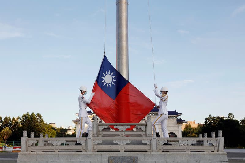 FILE PHOTO: Honour guard members take part in a flag-raising ceremony in Taipei