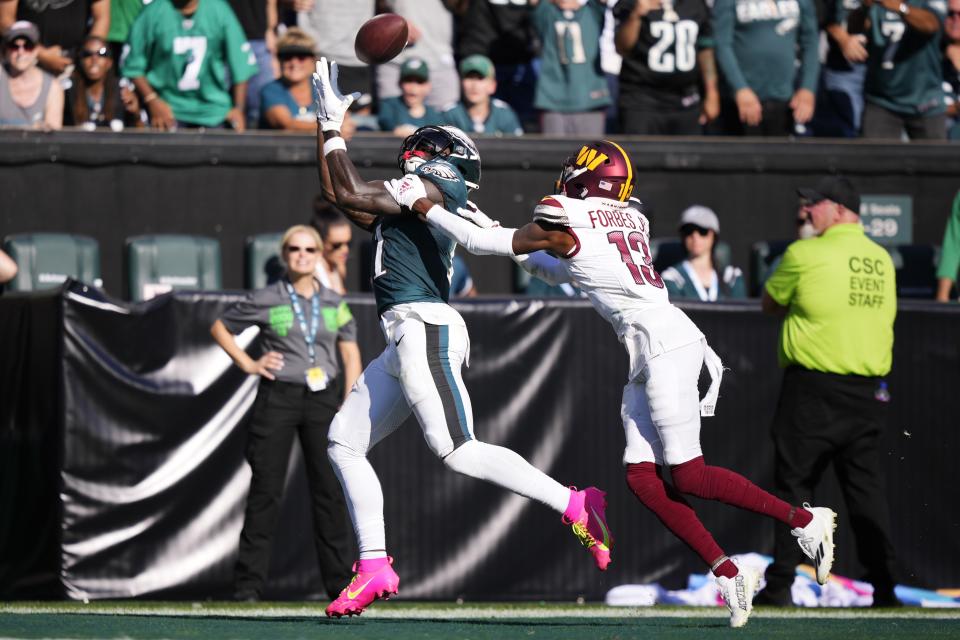 Philadelphia Eagles wide receiver A.J. Brown (11) reaches for a touchdown catch in front of Washington Commanders cornerback Emmanuel Forbes (13) during the second half of an NFL football game Sunday, Oct. 1, 2023, in Philadelphia. (AP Photo/Matt Slocum)