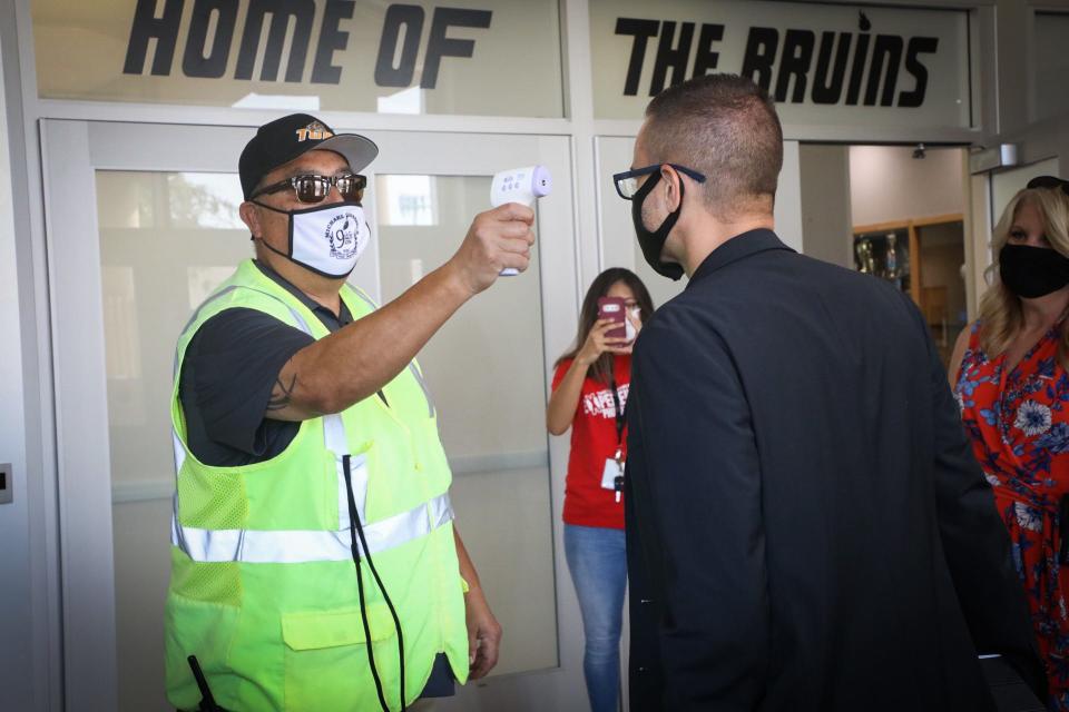 A temperature check at Trevor Browne High School in Phoenix.