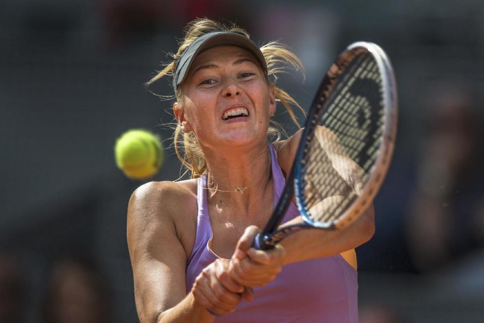 Maria Sharapova from Russia, returns the ball during a Madrid Open tennis tournament final match against Simona Halep from Romania, in Madrid, Spain, Sunday, May 11, 2014. (AP Photo/Andres Kudacki)
