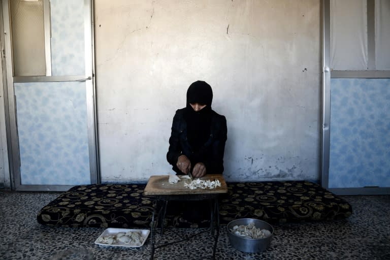 A Syrian woman prepares a meal using mushrooms in the rebel-held town of Douma where years of government siege have put traditional staples like meat beyond the reach of ordinary people