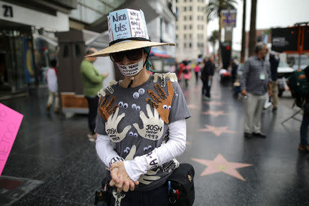 A woman who declined to give her name wears an outfit with the names of all the men in Hollywood who sexually harrassed her during a protest march for survivors of sexual assault and their supporters in Hollywood, Los Angeles, California U.S. November 12, 2017. REUTERS/Lucy Nicholson