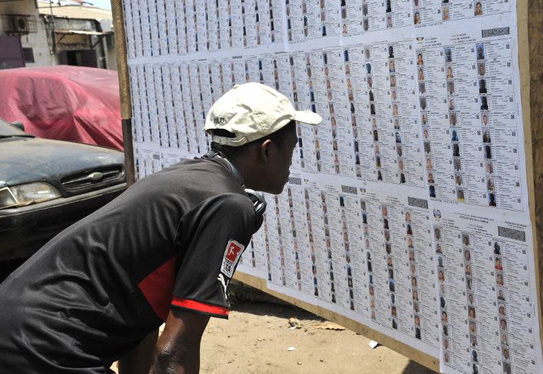A Guinean man looks at a list of candidates on May 2, 2015 in Conakry
