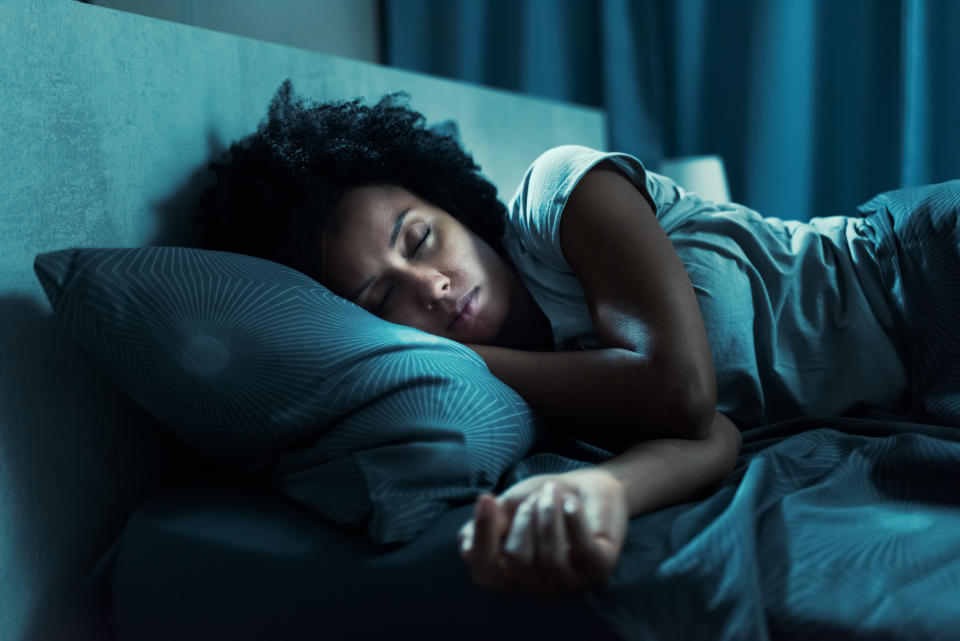 Woman in bed sleeping. (Getty Images)