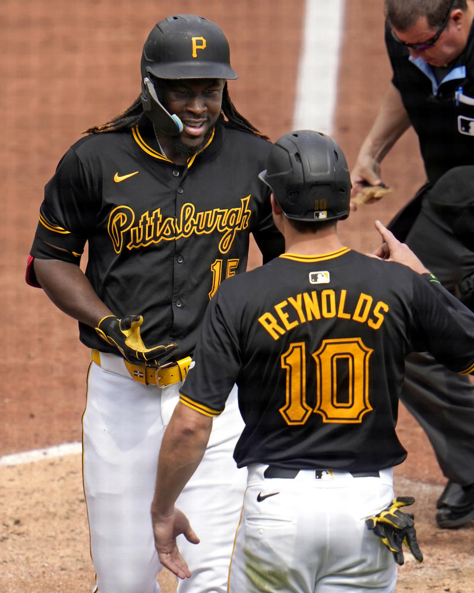 Pittsburgh Pirates' Oneil Cruz, left, is greeted by Bryan Reynolds (10) after they scored on Cruz's two-run home run off Colorado Rockies starting pitcher Ryan Feltner during the sixth inning of a baseball game in Pittsburgh, Sunday, May 5, 2024. (AP Photo/Gene J. Puskar)