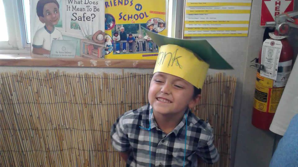 Frankie grins during his preschool graduation, celebrating with a hat he made himself. - Courtesy Lori Rosiles