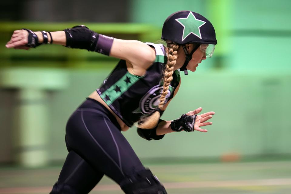 Ohio Roller Derby skater "Ratchet" Rachel Dement-Wilson races around the track during a scrimmage. From the skaters and officials to announcers and ticket-takers, the derby league is entirely volunteer-run.