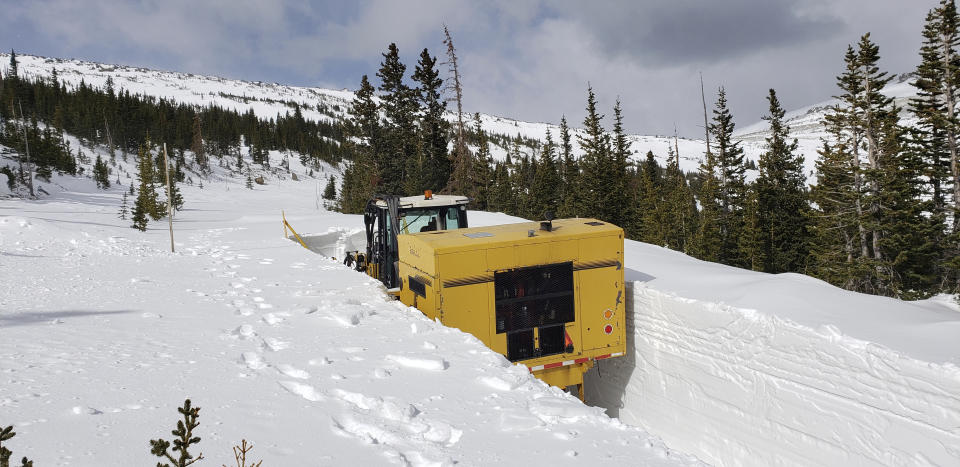 This undated photo provided by the National Park Service shows a snowplow on Trail Ridge Road in Rocky Mountain National Park, Colo., in late April. Heavy winter snow and a cold, wet May in the Rocky Mountains are sending a welcome surge of spring runoff into the rivers of the Southwestern U.S., fending off a water shortage but threatening to push some streams over their banks. (National Park Service via AP)