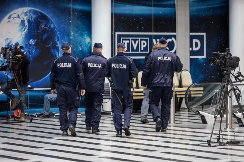 A group of police officers are seen entering the headquarters of Polish Public TV in Warsaw on December 20th, 2023.