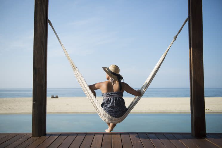 <i>[Woman sitting on a hamock at a small hotel in the coast of Oaxaca, Mexico. (Getty Images)]</i>