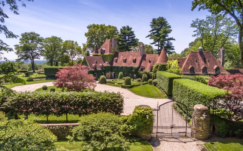 The park-like grounds center on a 13,000-square-foot mansion surrounded by rolling lawns, manicured hedges, water features and a tennis court.