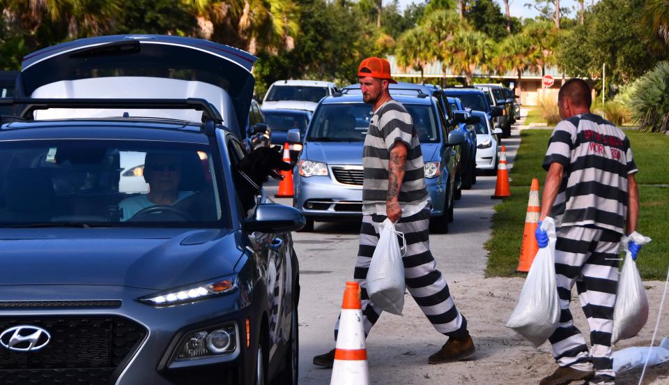 A steady flow of vehicles lined up Monday morning at Mitchell Ellington Park on north Merritt Island, where Brevard County supervised jail inmates filled and distributed free sandbags.