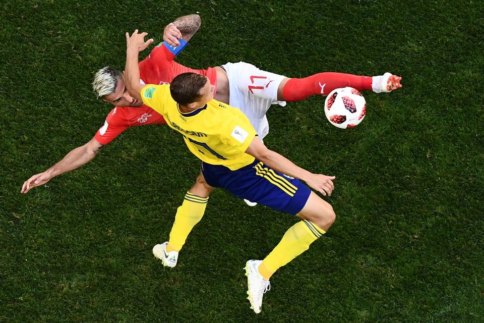 <p>Sweden’s midfielder Viktor Claesson vies with Switzerland’s midfielder Valon Behrami (top) during the Russia 2018 World Cup round of 16 football match between Sweden and Switzerland at the Saint Petersburg Stadium in Saint Petersburg on July 3, 2018. (Photo by Jewel SAMAD / AFP) </p>