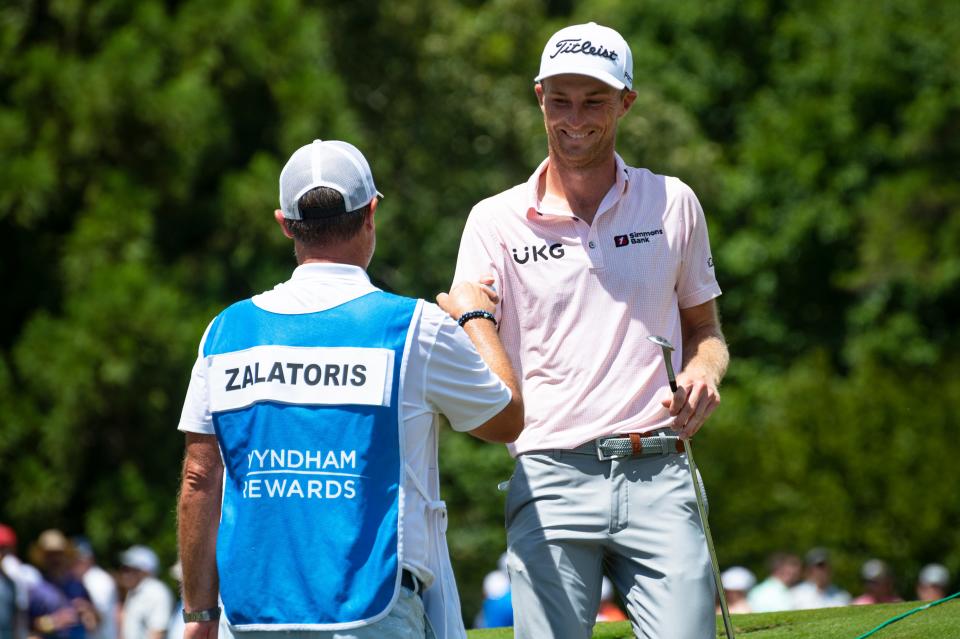 Will Zalatoris celebrates with fill-in caddie Josh Gregory, left, after chipping in for birdie on the 11th hole during Saturday’s third round of the Wyndham Championship at Sedgefield Country Club.